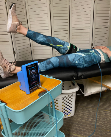 Blood flow restriction with a straight leg raise at Girl Fit Physical Therapy